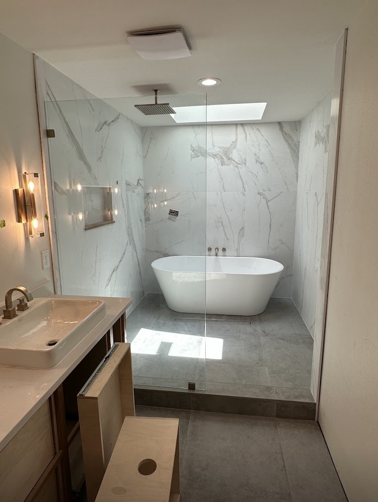 Bathroom remodel with marble shower and freestanding tub